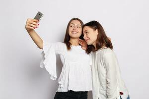 Beautiful girlfriends taking a self shot with phone. photo