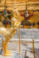 Golden Angle at Wat Phra Kaeo, Temple of the Emerald Buddha and the home of the Thai King. Wat Phra Kaeo is one of Bangkok's most famous tourist sites and it was built in 1782 at Bangkok, Thailand. photo