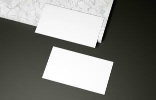 Business card on marble and black background photo