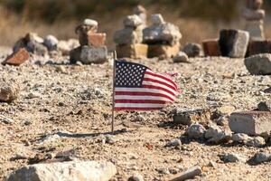 This beautiful American flag was in this sand monument that was created on the beach. I loved the look of this blowing in the wind with all the stones stacked up around it. Seemed very patriotic. photo