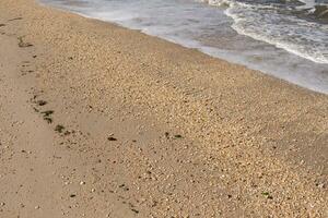 I loved the look of the ocean coming into the beach here. The sea foam slowly washing over the pretty pebbles some of which look like gems and are translucent all very smooth from being tumbled. photo