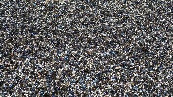 Rusty scrap metal shavings swirls in blue tone.Steel scrap materials recycling. video