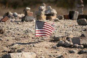 This beautiful American flag was in this sand monument that was created on the beach. I loved the look of this blowing in the wind with all the stones stacked up around it. Seemed very patriotic. photo