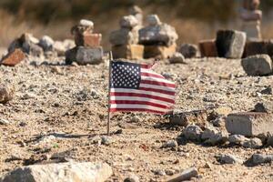 This beautiful American flag was in this sand monument that was created on the beach. I loved the look of this blowing in the wind with all the stones stacked up around it. Seemed very patriotic. photo