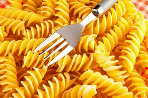 pasta with fork on a checkered tablecloth photo