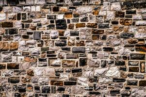 a wall made of stone with many different colors photo