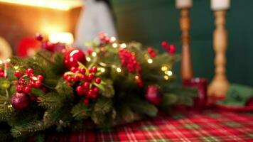 Close up Christmas wreath on the table at home. No people shot of cozy kitchen interior decorated for Christmas and New Year. Christmas floristics. High quality 4k footage video