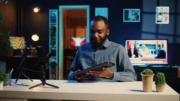 Online star films review of newly released laptop, unboxing it and presenting specs to audience. Influencer showing ultra slim notebook to fans, offering feedback of its performance video