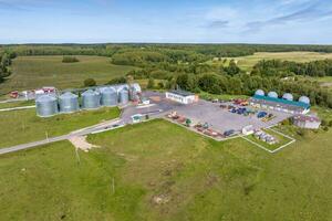 aerial view on agro silos granary elevator on agro-processing manufacturing plant for processing drying cleaning and storage of agricultural products photo