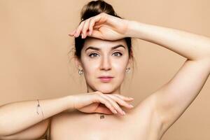 young woman face and hands over beige background photo