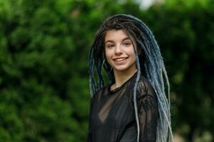 cheerful caucasian girl looking at the camera and smiling model with dreadlocks photo