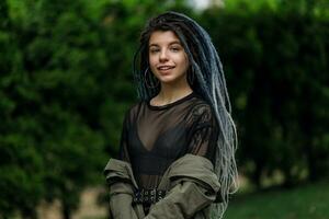 cheerful caucasian girl looking at the camera and smiling model with dreadlocks photo