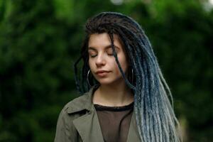 alegre caucásico niña mirando a el cámara y sonriente modelo con rastas foto