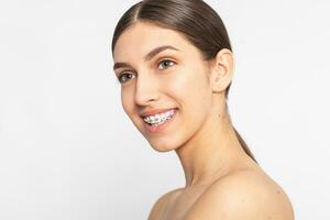 Close up portrait of Smiling Teen girl showing dental braces. photo