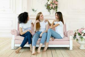 three girlfriends having a talk at home photo