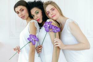 Portrait of three gorgeous multiracial young women with different types of skin photo