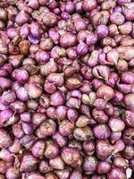 Red Onions are nicely stacked and piled up on this little market photo