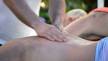 Physiotherapist massaging the back of a sportsman video