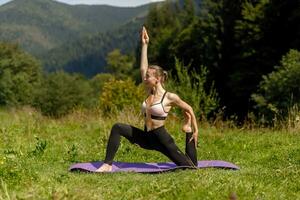 Fitness woman sitting in a yoga pose in a park. photo
