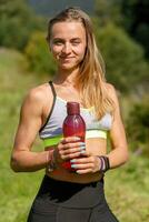 Fit young woman stretching legs and looking at camera. photo