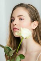 Little pretty girl in pink holds the bouquet of roses. photo