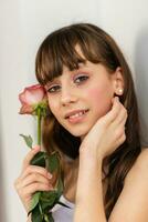 Little pretty girl in pink holds the bouquet of roses. photo