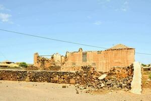 an old building with a wall and a fence photo