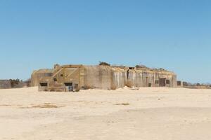 This is the World War 2 bunker in Cape May New Jersey. Used to sit in the ocean, but due to all the sand piling up it is now inshore. This was built to blend in from enemy fighters. photo