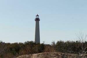 This is the Cape May point lighthouse located in the southernmost tip of New Jersey. This beacon of hope stands tall to help prevent sailors from wrecking and also letting them know where they are. photo
