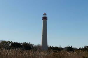This is the Cape May point lighthouse located in the southernmost tip of New Jersey. This beacon of hope stands tall to help prevent sailors from wrecking and also letting them know where they are. photo
