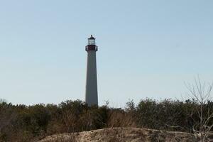 This is the Cape May point lighthouse located in the southernmost tip of New Jersey. This beacon of hope stands tall to help prevent sailors from wrecking and also letting them know where they are. photo