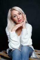 Portrait of a beautiful young attractive woman in a white sweater photo