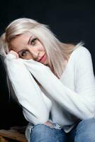 Portrait of a beautiful young attractive woman in a white sweater photo