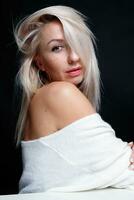 Portrait of a beautiful young attractive woman in a white sweater photo