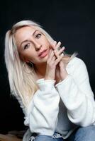 Portrait of a beautiful young attractive woman in a white sweater photo