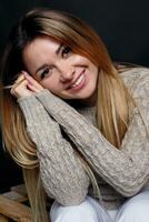 Portrait of beautiful red haired female in grey melange sweater photo