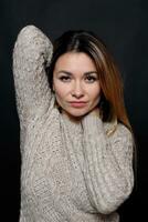 Portrait of beautiful red haired female in grey melange sweater photo