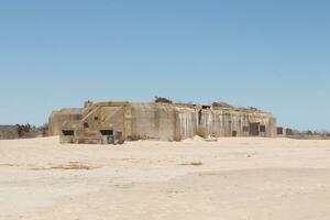 This is the World War 2 bunker in Cape May New Jersey. Used to sit in the ocean, but due to all the sand piling up it is now inshore. This was built to blend in from enemy fighters. photo