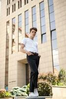 Handsome young hipster stylish man in white shirt, black pants photo