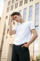 Handsome young hipster stylish man in white shirt, black pants photo