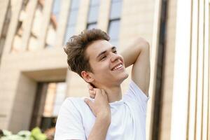 Handsome young hipster stylish man in white shirt, black pants photo