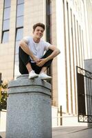 Handsome young hipster stylish man in white shirt, black pants photo