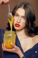 Girl with jar of honey. Healthy food concept, diet, dessert photo