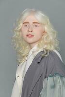 beautiful albino girl with white skin, natural lips and white hair photo