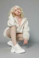 beautiful albino girl with white skin, natural lips and white hair photo