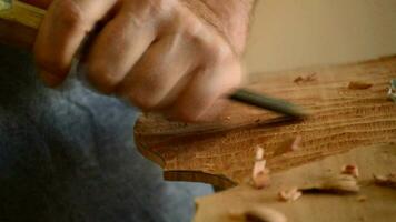Luthier manufacturing a instrument with a chisel video