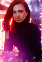 Portrait of a girl on the background of a neon sign of a shop window photo