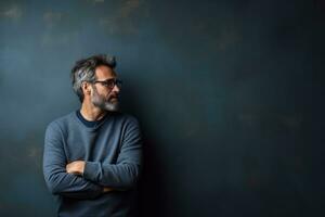 Introverted leader in contemplative pose moody indigo study background with empty space for text photo