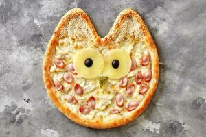 Owl-shaped pizza for kids with cream cheese sauce, chicken, Vienna sausage, pineapple, olives, pickled cucumber and sesame photo