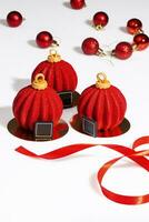 Red and gold pastries in shape of Christmas balls on table photo